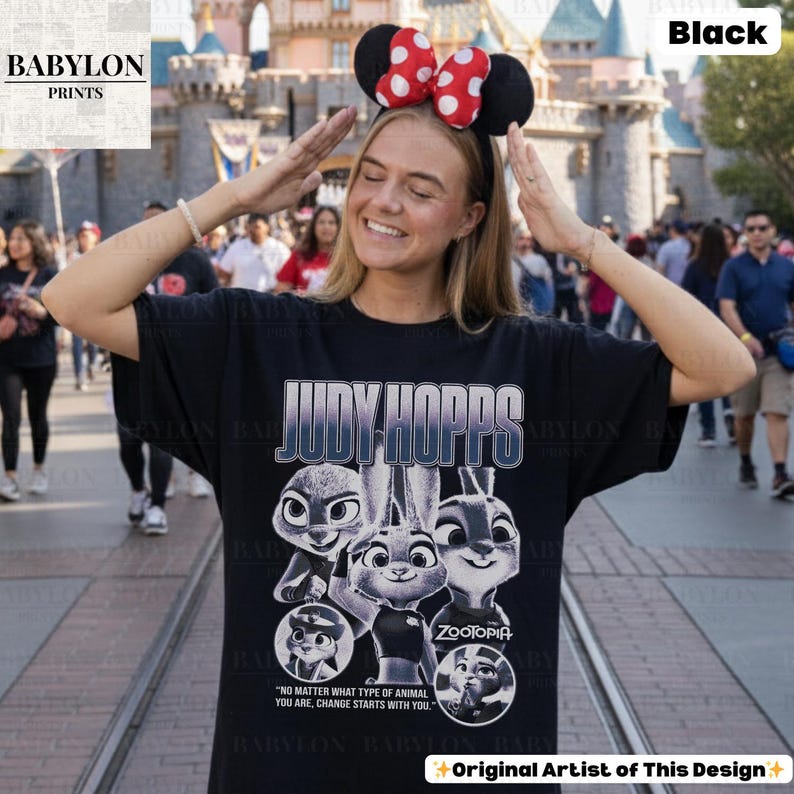 May include: Black t-shirt featuring the text "JUDY HOPPS" and images of characters from the movie Zootopia. The shirt also includes the quote "NO MATTER WHAT TYPE OF ANIMAL YOU ARE, CHANGE STARTS WITH YOU."