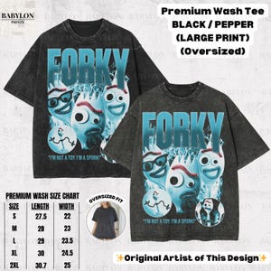 May include: Black and pepper oversized t-shirts with a large Forky graphic. The design features Forky characters with the text "FORKY" in blue and the quote "I'M NOT A TOY. I'M A SPORK!". Includes a size chart.