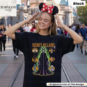 May include: A white ceramic mug with a black handle and the text "But First, Coffee" in a black, handwritten-style font. The mug is on a white surface.