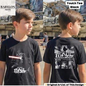 May include: Black youth tee featuring a Star Wars design. The front graphic shows Darth Maul with a red lightsaber and the text "MAUL SHADOW LORD." The back displays a larger image of Darth Maul and additional character portraits.