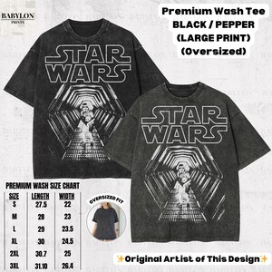 May include: Black and pepper-colored oversized Star Wars graphic tee. The front features the Star Wars logo and a detailed graphic of a hallway with characters. The shirt includes a size chart and the text "Original Artist of This Design."