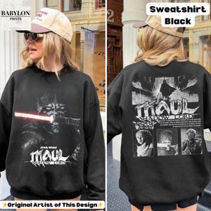 May include: Black sweatshirt featuring a Star Wars Darth Maul graphic with a red lightsaber. The front of the sweatshirt has the text "MAUL SHADOW LORD". The back of the sweatshirt has the text "MAUL SHADOW LORD" and three images.