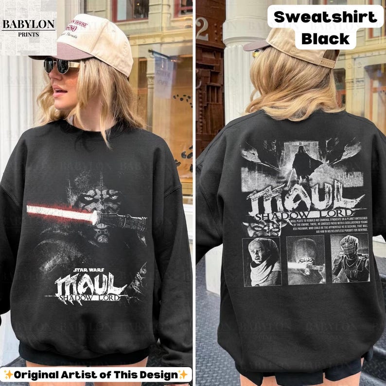 May include: Black sweatshirt featuring a Star Wars Darth Maul graphic with a red lightsaber. The front of the sweatshirt has the text "MAUL SHADOW LORD". The back of the sweatshirt has the text "MAUL SHADOW LORD" and three images.