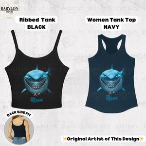 May include: Black ribbed tank top and navy tank top featuring a cartoon shark with the word "Nemo". The black tank top has a scoop neck, and the navy tank top has a racerback design. The image also includes the text "Original Artist of This Design".