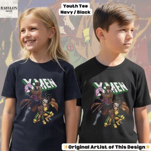 May include: Navy blue and black youth tees featuring an X-Men graphic. The design includes the word "X-MEN" in white and green, along with illustrations of Gambit and Rogue. The shirts are from Babylon Prints.