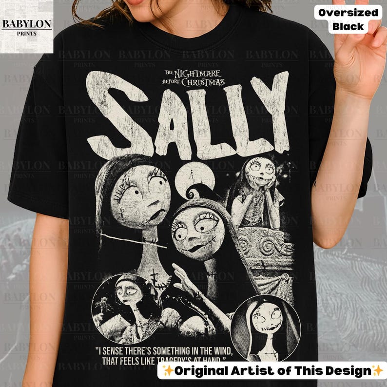 May include: Black oversized t-shirt featuring a graphic of Sally from "The Nightmare Before Christmas." The design includes multiple images of Sally with the film's title in large, distressed white letters. Text at the bottom reads, "I sense there's something in the wind..."