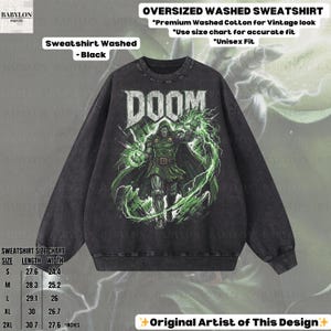 May include: Black washed oversized sweatshirt featuring a graphic of a character with the word "DOOM" in white. The character is in green and black, with green lightning effects. The sweatshirt has a crew neck and long sleeves. The text "Original Artist of This Design" is at the bottom.