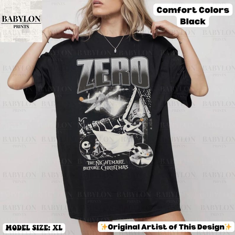 May include: Black t-shirt featuring a graphic design with the word "ZERO" and characters from "The Nightmare Before Christmas." The shirt is labeled "Comfort Colors" and "Original Artist of This Design."