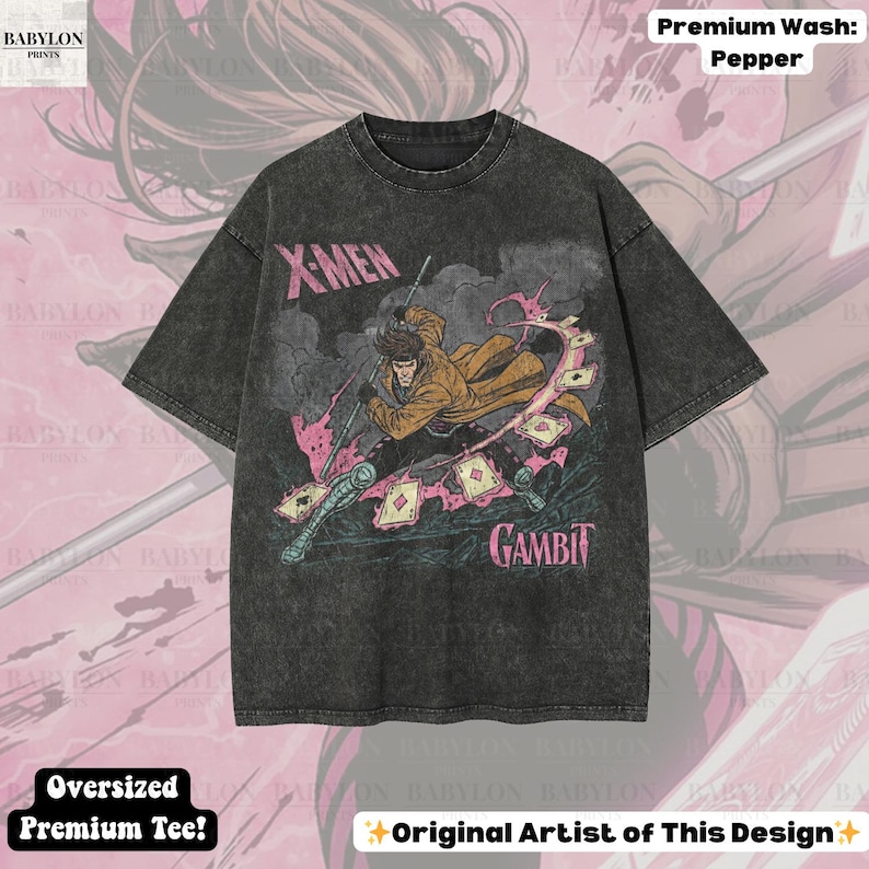 May include: A dark gray oversized t-shirt featuring a graphic of the X-Men character Gambit. The design includes the character in a dynamic pose with playing cards and the text "X-Men" and "Gambit". The shirt has a "Premium Wash: Pepper" finish.