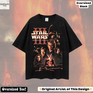 May include: Black oversized t-shirt featuring a graphic from Star Wars: Revenge of the Sith. The design includes characters like Darth Vader, Anakin Skywalker, and Obi-Wan Kenobi. The shirt has the text "Star Wars III Revenge of the Sith".