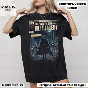 May include: Black t-shirt featuring a Star Wars comic book cover design. The graphic includes the text "STAR WARS - SPECIAL VARIANT EDITION ORDER 66 THE FALL OF THE JEDI". The shirt also has the text "BABYLON PRINTS" and "Original Artist of This Design".