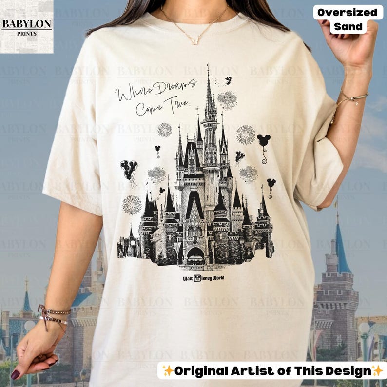 May include: Oversized sand-coloured t-shirt with a black and white castle illustration, the text "Where Dreams Come True", and "Walt Disney World". The shirt also has the text "Original Artist of This Design."