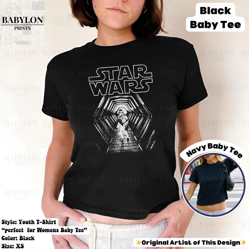 May include: Black youth t-shirt featuring the Star Wars logo and a black and white graphic of a hallway. The shirt is a baby tee style. The text "STAR WARS" is in white block letters. The shirt is XS size.