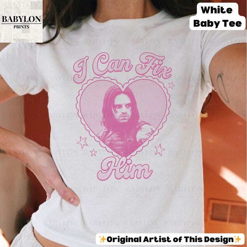 May include: White baby tee with a pink heart graphic. The heart contains a portrait and the words "I Can Fix Him". The design includes stars and the text "Original Artist of This Design".