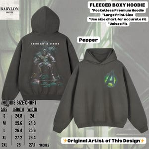 May include: Pepper-colored fleeced boxy hoodie with a large print design. The back features a graphic of a figure with the text "DOOMSDAY IS COMING." The front displays an Avengers logo. Available in sizes S (24.8" length, 24" width) to 2XL (28" length, 27.1" width).