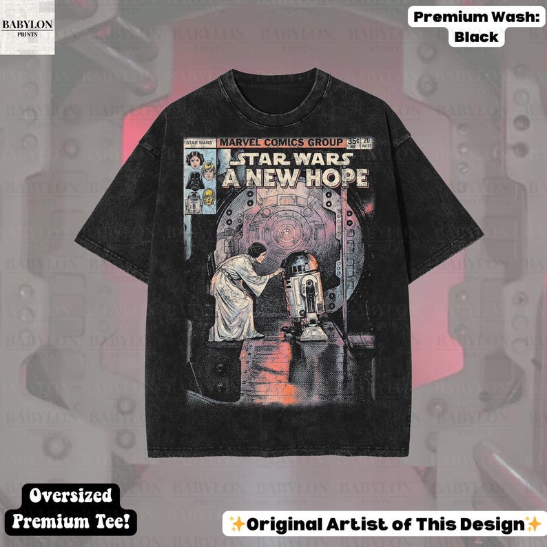 May include: Black oversized t-shirt featuring a comic book-style graphic from Star Wars: A New Hope. The design includes Princess Leia and R2-D2. The shirt has the text "STAR WARS A NEW HOPE" and "MARVEL COMICS GROUP".