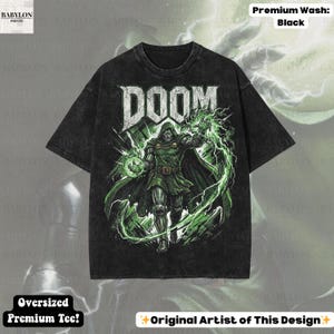 May include: Black oversized premium tee featuring a graphic of a character with the word "DOOM" in white. The character is in green and silver with green lightning effects. The shirt has the text "Original Artist of This Design".