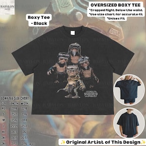 May include: A black boxy t-shirt featuring a graphic print of four Ewok characters from Star Wars. The shirt has short sleeves and a crew neckline. Text on the shirt includes "STAR WARS" and "Boxy Tee - Black" with a size chart in inches.