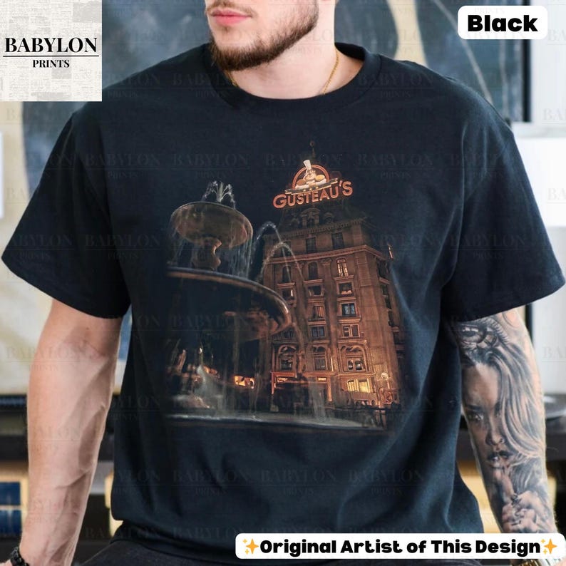 May include: Black t-shirt with a graphic of a fountain and a building, with the text "GUSTEAU'S" in red. The shirt also has the text "Original Artist of This Design". The Babylon Prints logo is in the upper left corner.