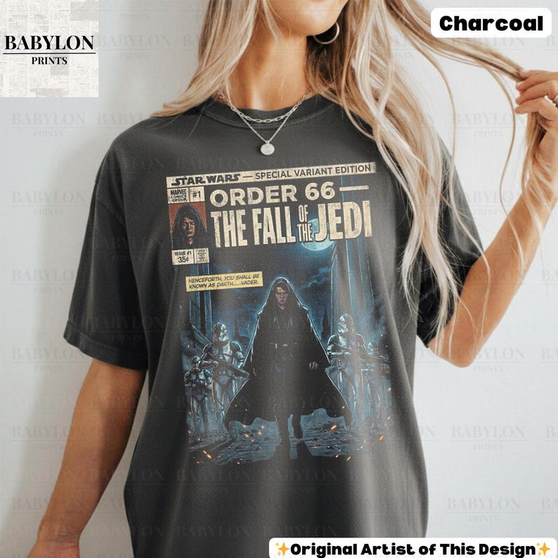 May include: Charcoal-colored t-shirt featuring a Star Wars comic book cover design. The graphic reads "Order 66: The Fall of the Jedi" with Darth Vader and Stormtroopers. The shirt has a vintage, distressed look.