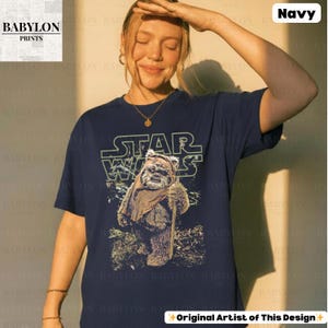 May include: A white ceramic mug with a black handle and the text "But First, Coffee" in a black, handwritten-style font. The mug is on a white surface.