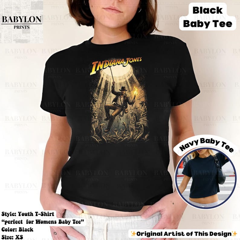 May include: Black youth t-shirt featuring the Indiana Jones movie logo and a graphic of the character. The shirt includes the text "Indiana Jones" in yellow. The shirt is XS size.
