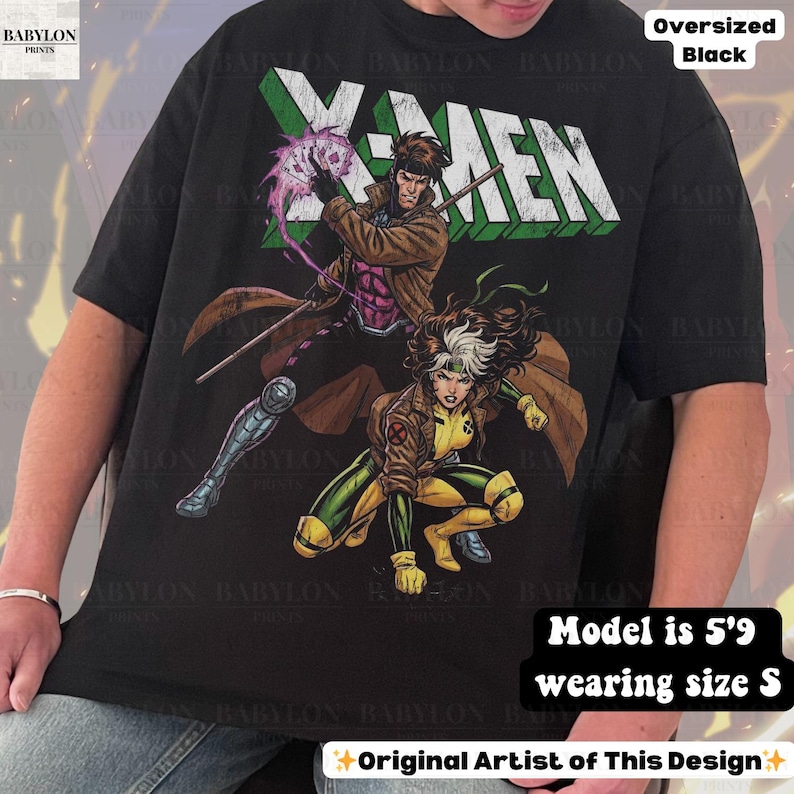 May include: Black oversized t-shirt featuring a graphic of X-Men characters Gambit and Rogue. The X-MEN text is in white and green. The shirt has the text "Original Artist of This Design".