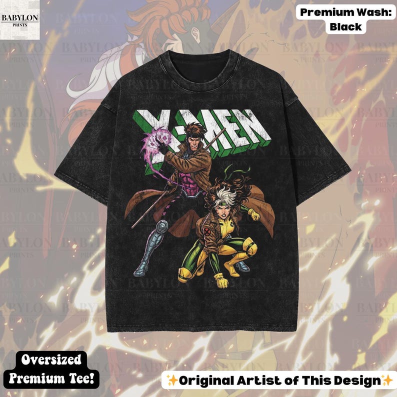 May include: Black oversized premium tee featuring a graphic of X-Men characters Gambit and Rogue. The X-MEN logo is in white and green. The shirt has a distressed look and the text "Original Artist of This Design" is at the bottom.