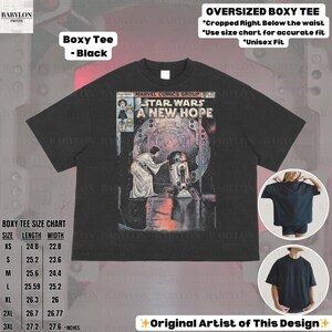 May include: Black boxy tee featuring a Star Wars comic book cover. The graphic includes the text "STAR WARS A NEW HOPE" and images of characters. The shirt has a crew neck and short sleeves. Size chart included.