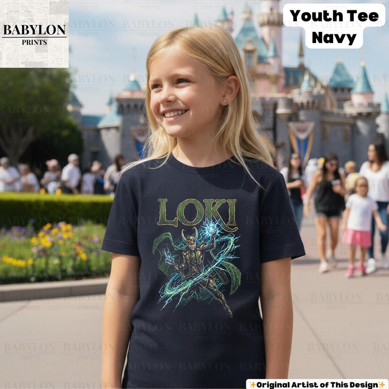 May include: A navy blue youth tee featuring the word "LOKI" in green lettering above a graphic of the character. The design includes a figure with a horned helmet, green cape, and blue energy effects. The shirt is worn by a young person.