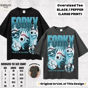 May include: Two oversized black and pepper-colored t-shirts with a large print of Forky from Toy Story. The design includes the word "Forky" in blue, along with Forky's face and the text "I'm not a toy. I'm a Spork!"