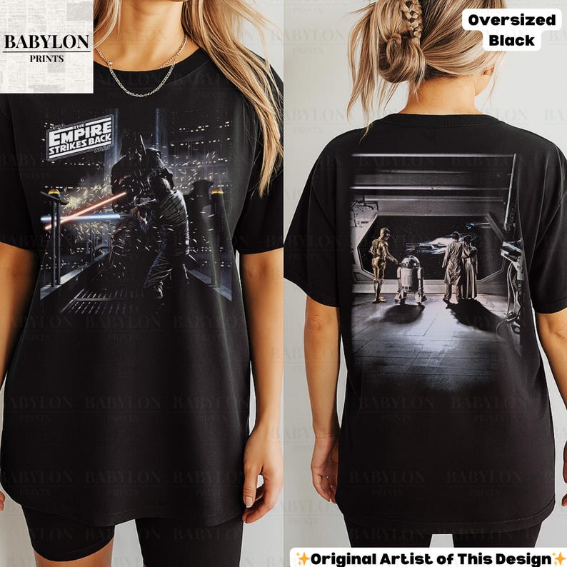 May include: Black oversized t-shirt featuring a Star Wars design. The front graphic shows a scene from "The Empire Strikes Back" with Darth Vader. The back of the shirt displays a scene with C-3PO, R2-D2, and other characters. The text "Oversized Black" is visible.