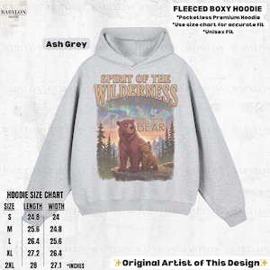 May include: Ash grey fleeced boxy hoodie with a "Spirit of the Wilderness" graphic featuring a bear and cub. The hoodie has a pocketless design and is available in sizes S to 2XL, with lengths from 63 cm to 71 cm and widths from 61 cm to 69 cm.