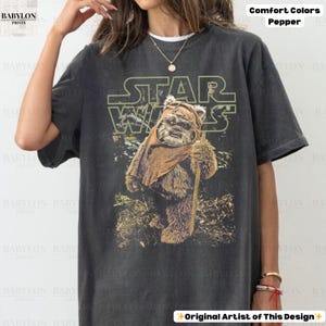 May include: A set of three ceramic mugs with a speckled, matte finish. The mugs are in shades of cream, light gray, and dark gray. Each mug has a simple, minimalist design, perfect for coffee or tea.