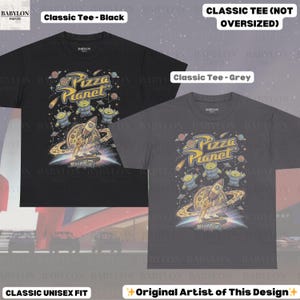 May include: Two classic unisex fit t-shirts, one black and one grey, featuring a Pizza Planet graphic. The design includes aliens, a rocket, and the text "Pizza Planet". The shirts are labeled "Classic Tee" and "Classic Tee (Not Oversized)".