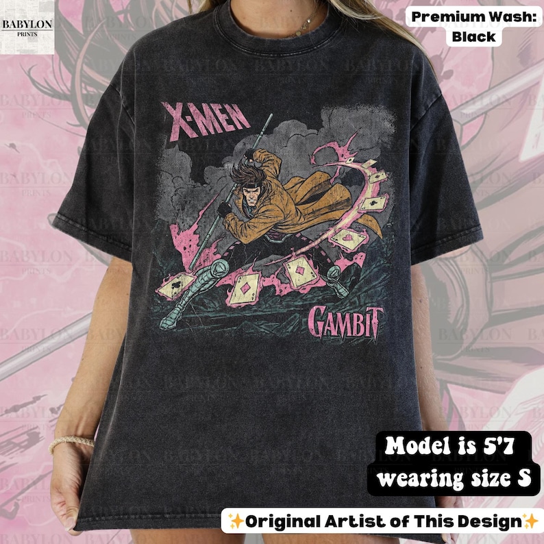 May include: Black t-shirt featuring a graphic of the X-Men character Gambit. The design includes Gambit with playing cards and the text "X-Men" and "Gambit". The shirt is a premium wash.