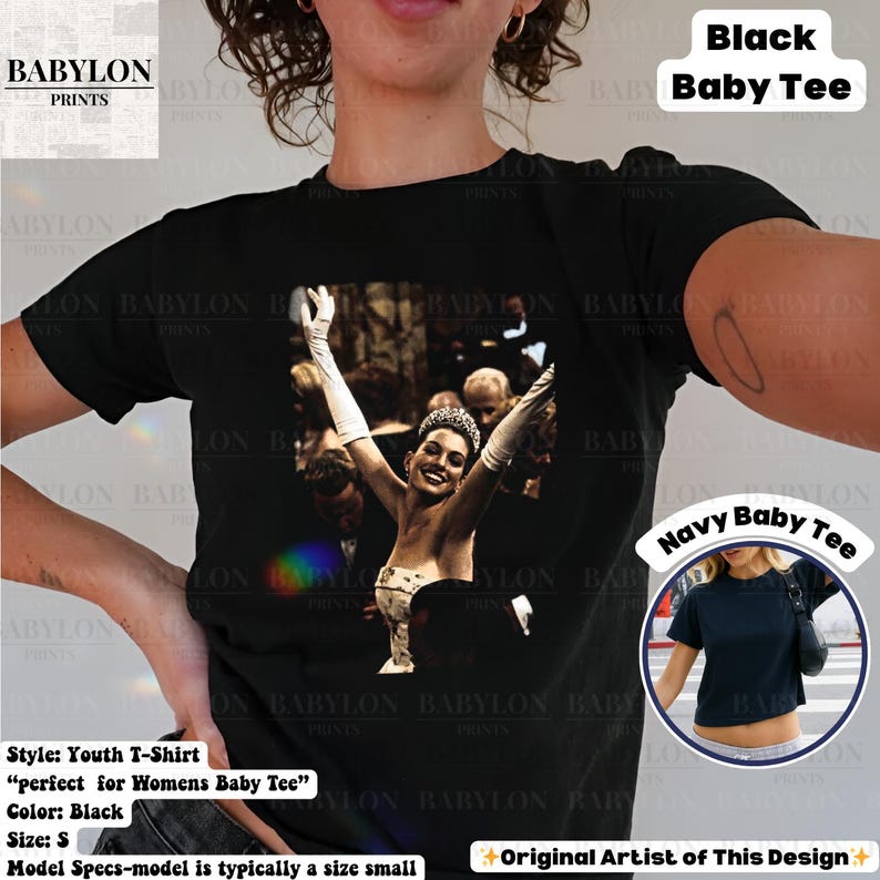 May include: Black youth t-shirt with a black and white image of a woman with her arms raised. The shirt has the text "Black Baby Tee" printed on it. The shirt is a size small.