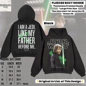 May include: Black fleece boxy hoodie with a Star Wars theme. The front features Luke Skywalker with a green lightsaber, and the back displays the text "I am a Jedi, like my father before me." The hoodie has a size chart in inches.