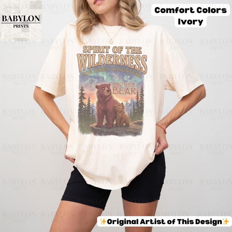 May include: Ivory t-shirt featuring the text "Spirit of the Wilderness" and a graphic of two bears. The shirt also has the text "Brother Bear" and "Northern Adventure". Made of Comfort Colors material.