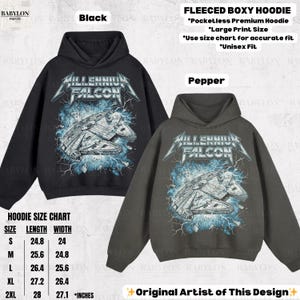 May include: Black and pepper-colored fleeced boxy hoodies with a Millennium Falcon graphic. The design features the text "Millennium Falcon" in a metallic font, with the ship and lightning bolts. The size chart is included.