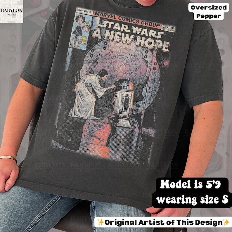 May include: Dark gray oversized t-shirt featuring a Star Wars comic book cover design. The graphic includes the text "STAR WARS A NEW HOPE" and images of characters. The shirt is a size S.