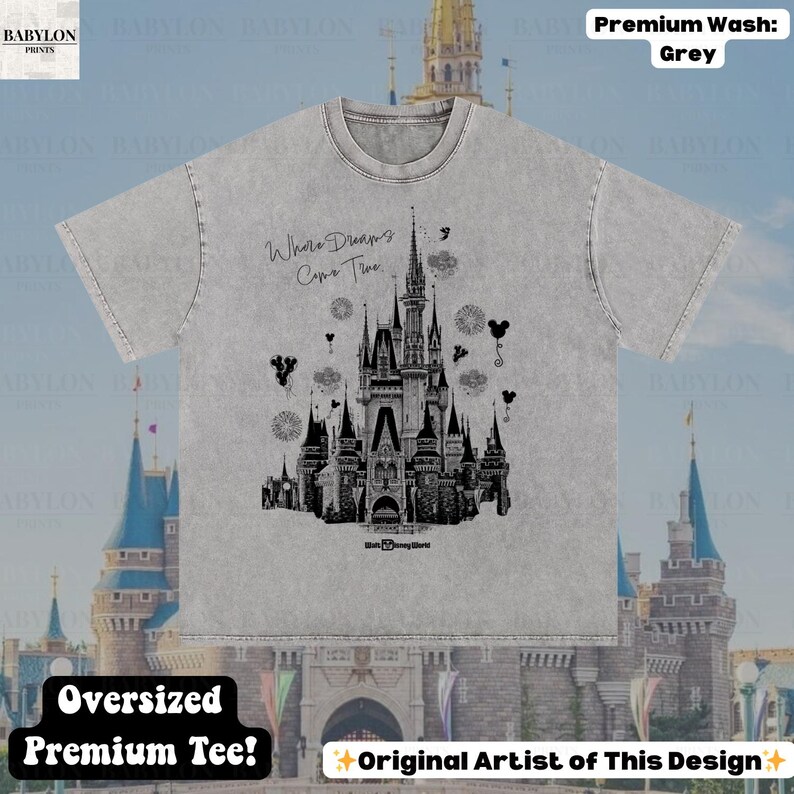 May include: Grey oversized premium tee with a black and white castle illustration and the text "Where Dreams Come True." The design includes Mickey Mouse silhouettes and fireworks. The shirt is made of a soft, comfortable material.