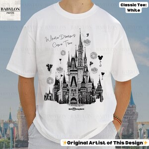 May include: White classic tee with a black and white castle illustration, the text "Where Dreams Come True", and "Walt Disney World". The shirt also has the text "Original Artist of This Design".