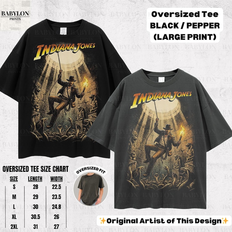 May include: Two oversized black and pepper-colored t-shirts with a large Indiana Jones graphic print. The graphic features Indiana Jones in a scene with a torch and rope. A size chart is included, with lengths from 28 to 31 inches.