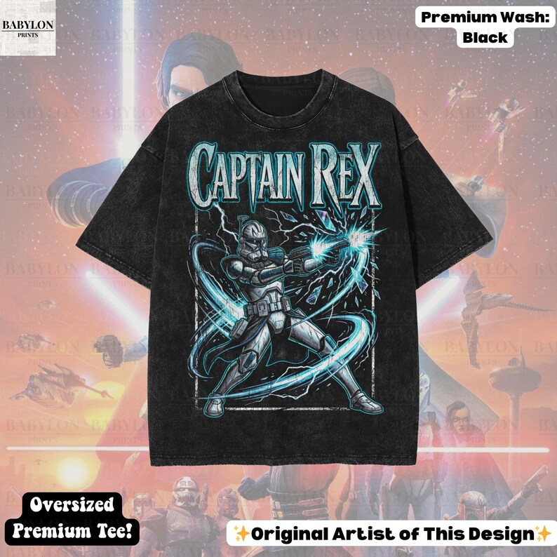 May include: Black oversized premium tee with a graphic of Captain Rex and the text "CAPTAIN REX". The design shows a character in white and grey armour firing a weapon with blue energy effects. The shirt has the text "Original Artist of This Design".