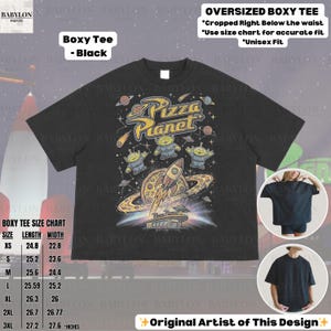 May include: Black oversized boxy tee featuring a Pizza Planet graphic with aliens, a rocket, and the text "Pizza Planet." The shirt includes a size chart and the text "Original Artist of This Design."