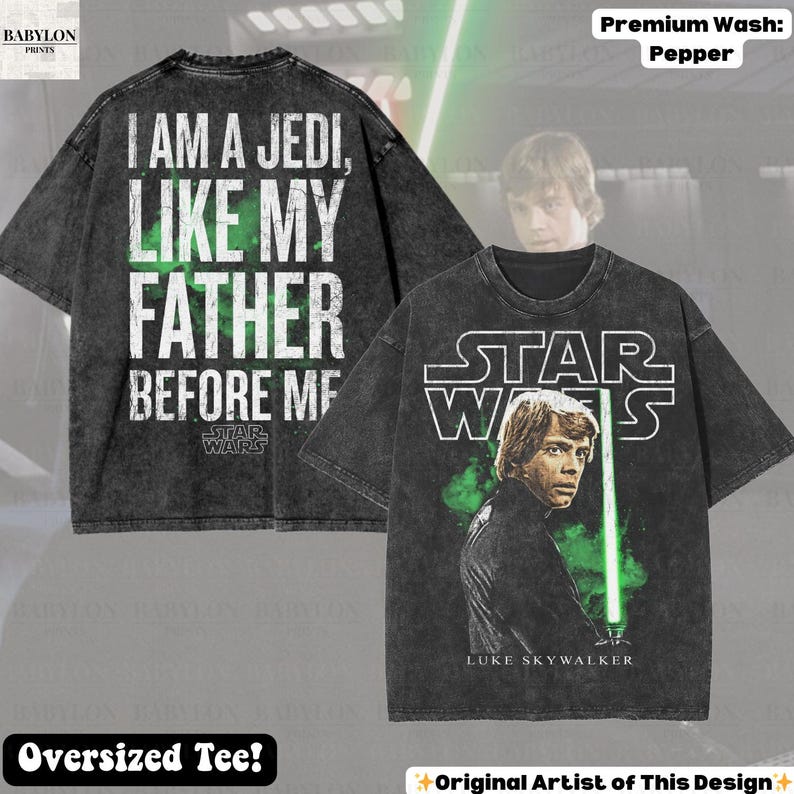 May include: A dark gray oversized t-shirt featuring Luke Skywalker with a green lightsaber and the Star Wars logo. The back of the shirt displays the text "I AM A JEDI, LIKE MY FATHER BEFORE ME."