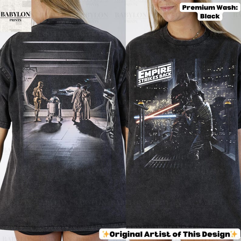 May include: Black t-shirt featuring Star Wars imagery. The front displays a scene with Darth Vader, while the back shows C-3PO, R2-D2, and other characters. The text "THE EMPIRE STRIKES BACK" is also visible.