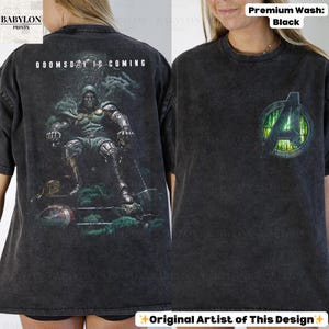 May include: Black t-shirt with a graphic of a seated figure and the text "DOOMSDAY IS COMING" on the back. The front features an Avengers logo. The shirt is a premium wash.