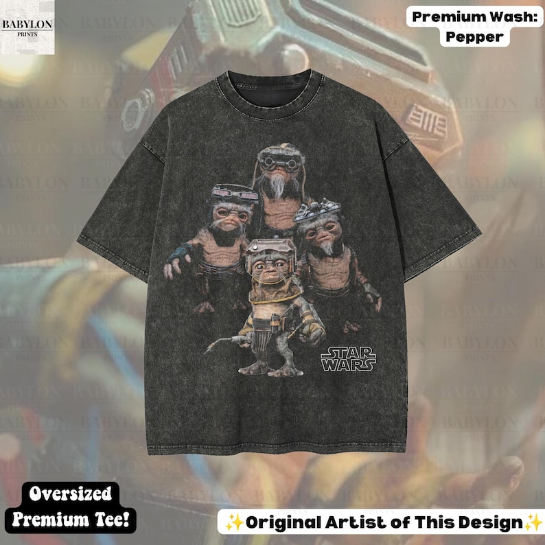 May include: A charcoal grey, acid-washed, oversized short-sleeve t-shirt featuring a graphic print of four Ewok characters from Star Wars. The Star Wars logo is printed in white text on the lower right side of the graphic. The shirt has a crew neckline.
